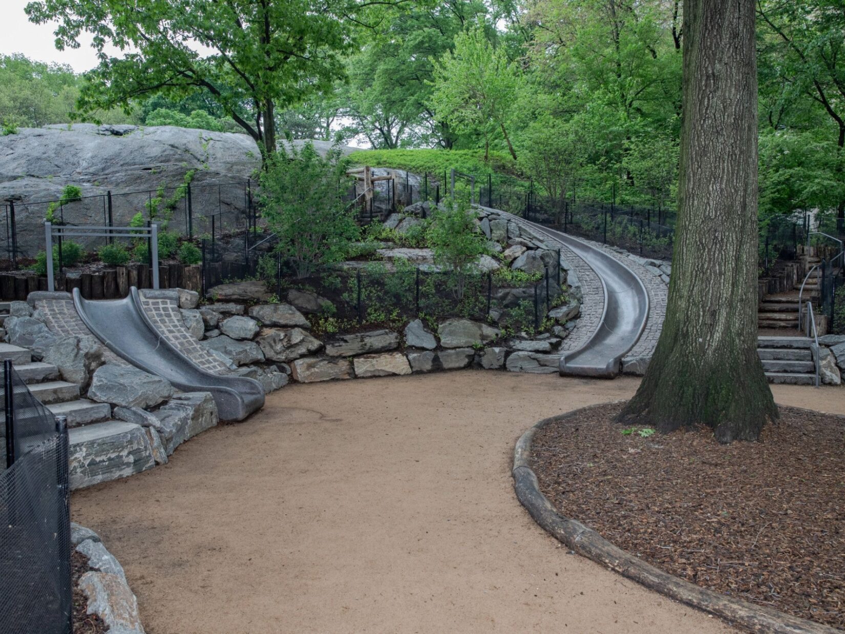 The playground is shown integrated into the landscape.