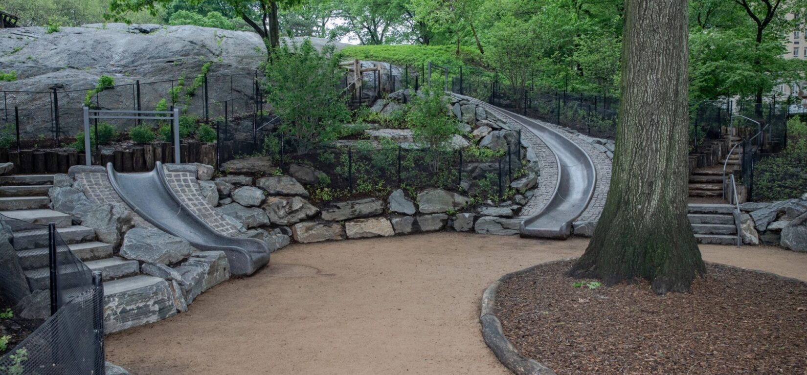 The playground is shown integrated into the landscape.