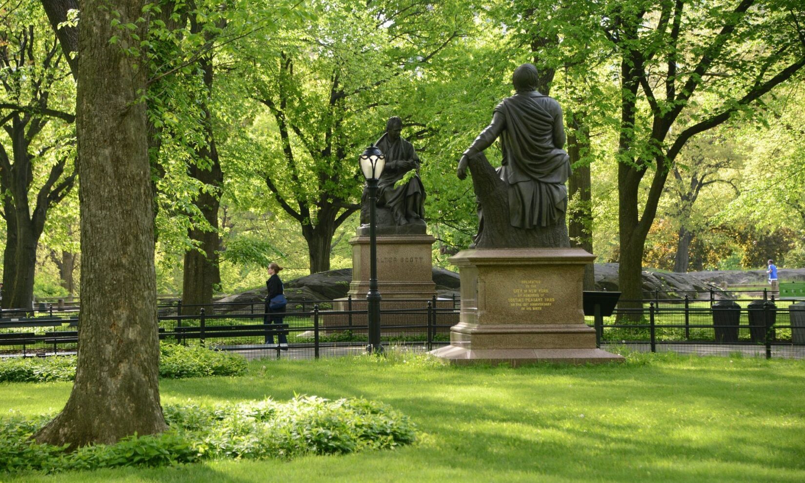 The poets Robert Burns and Sir Walter Scott face each other, as statues, from either side of the path of the Mall.