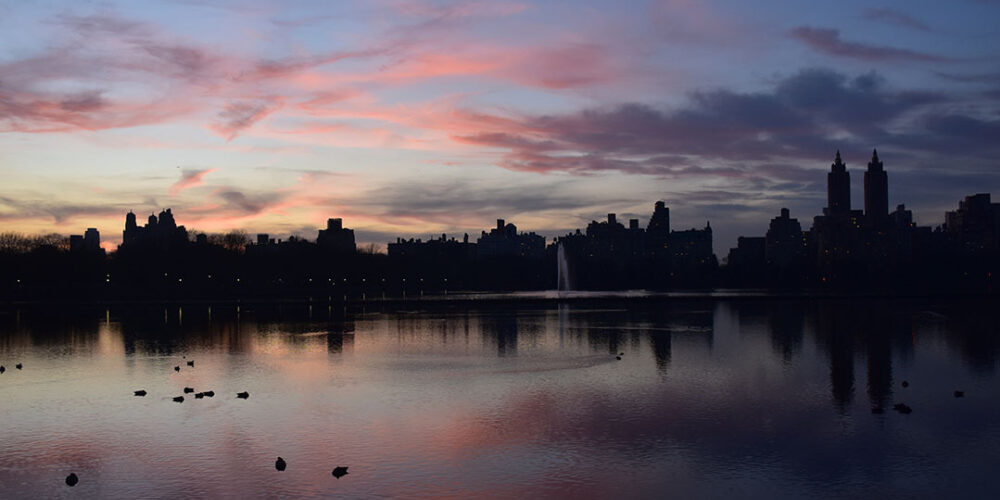 Sunset is reflected on the still surface of the Reservoir