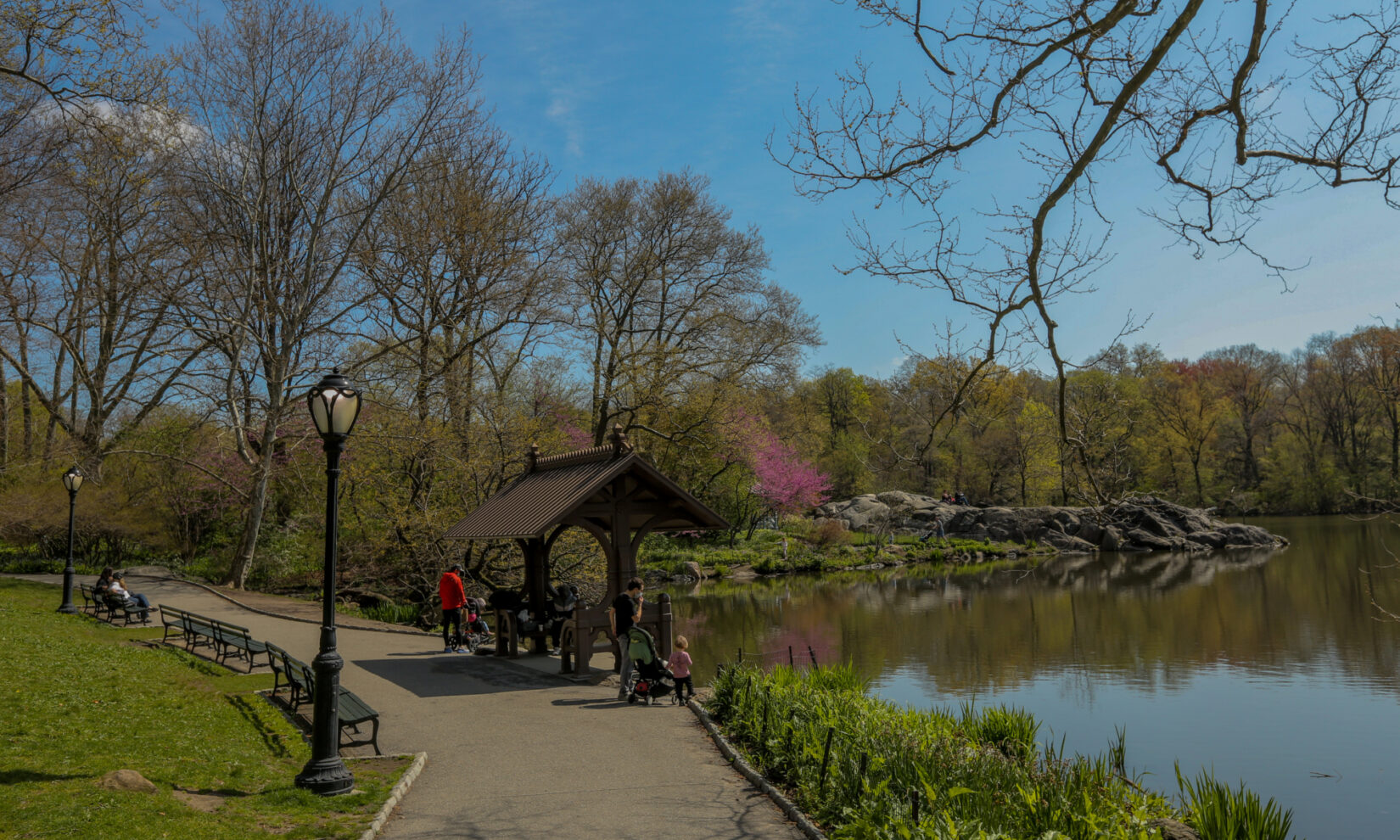 Young families enjoy the springtime view from the shelter of the boat landing.