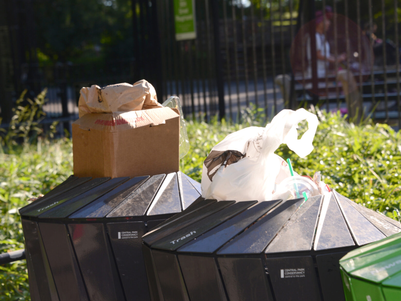 Boxes and bags of litter overflowing from trash containers