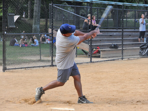 A batter finishes their swing at the plate