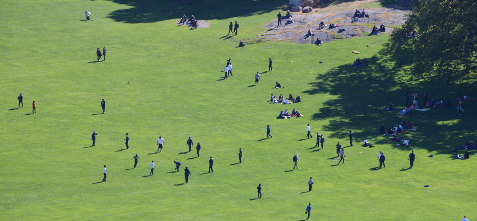 An aerial view of the Sheep Meadow showing people playing football