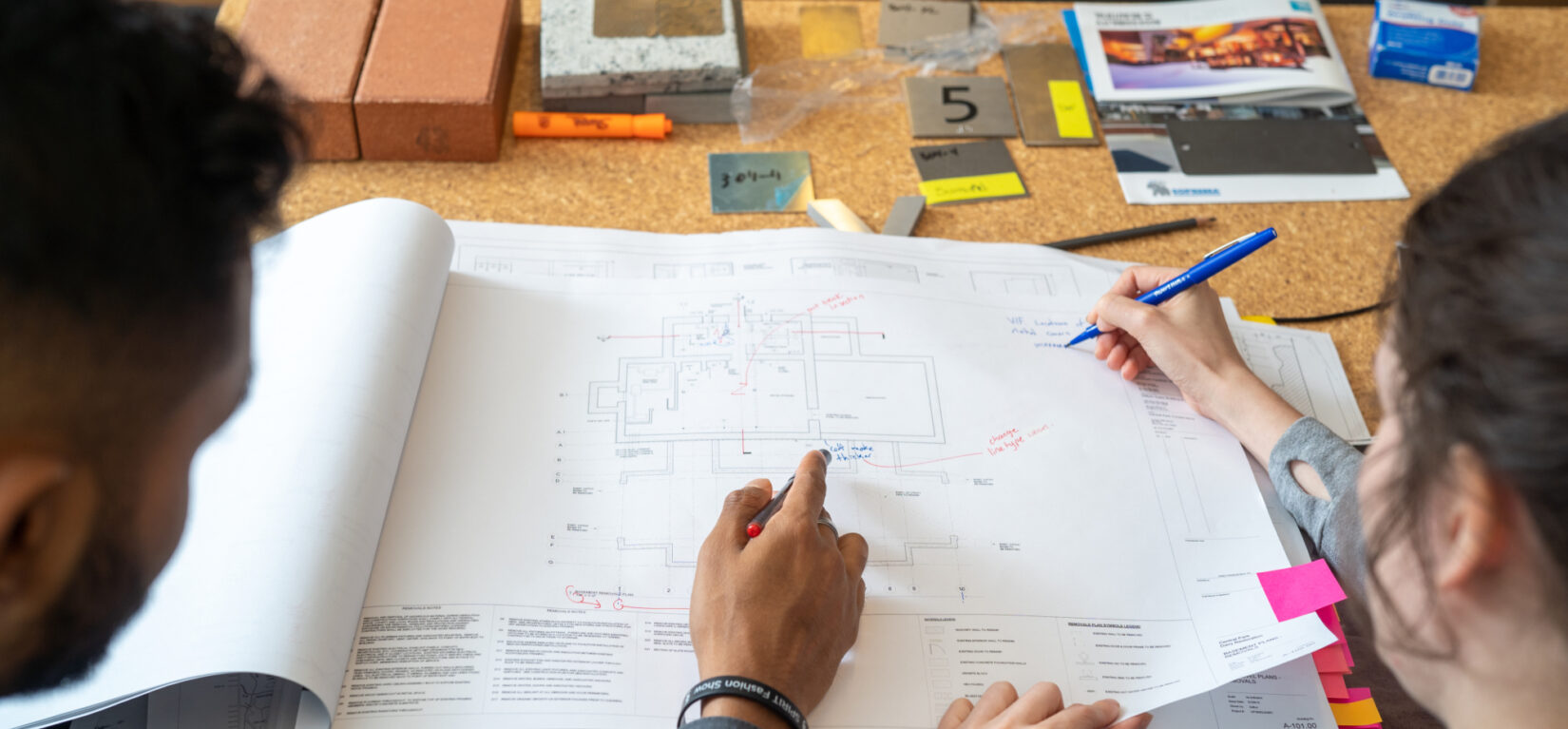 Conservancy designers review an elevation and make notes