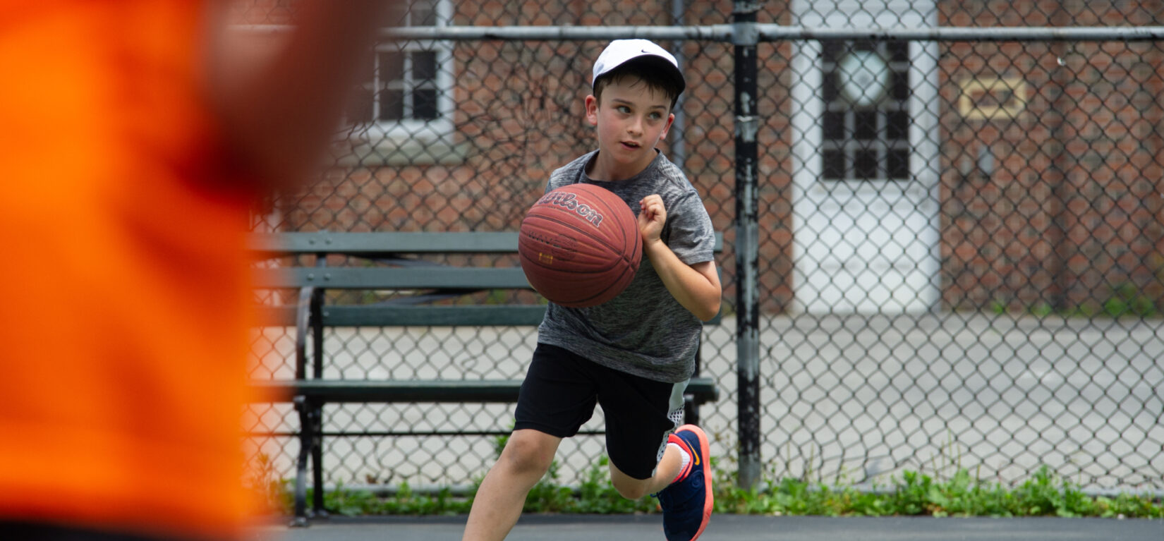 A young baller caught in mid-dribble