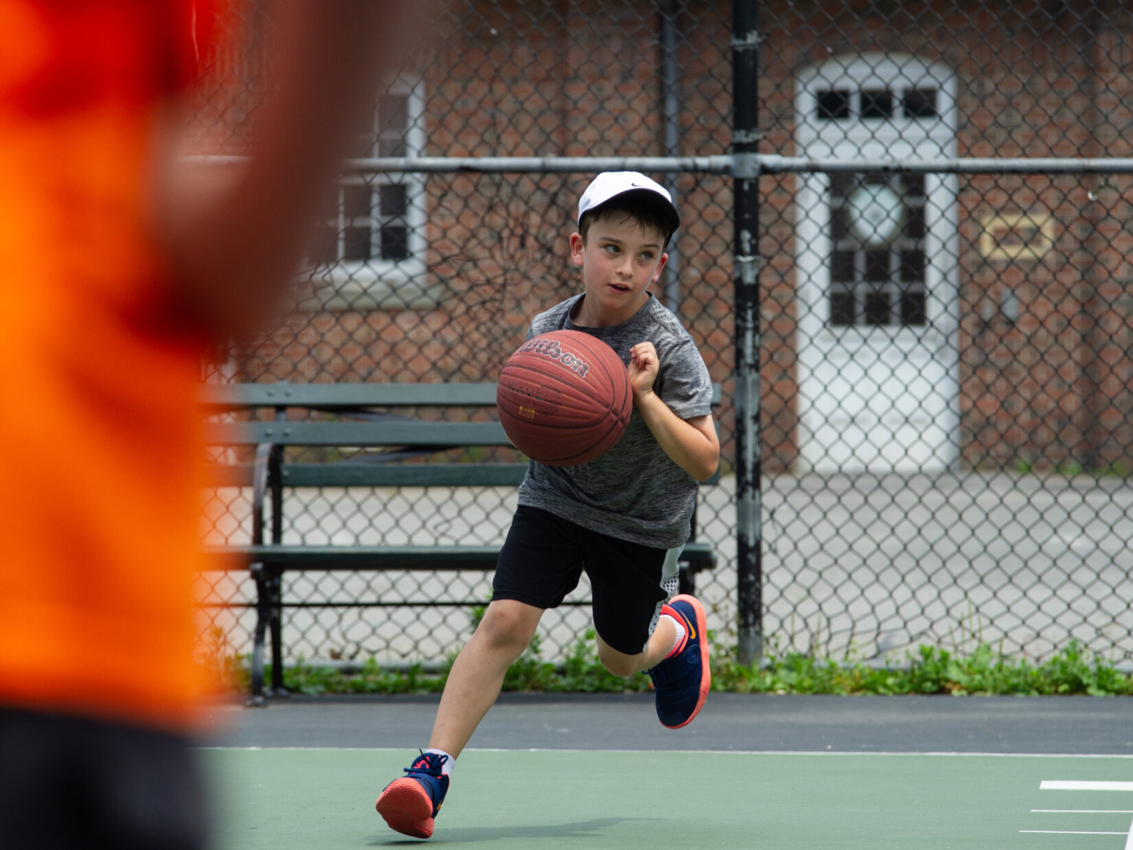 A young baller caught in mid-dribble