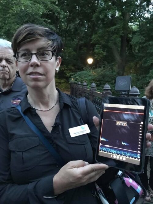 Danielle Gustafson holding a tablet computer demonstrating an echolocation app