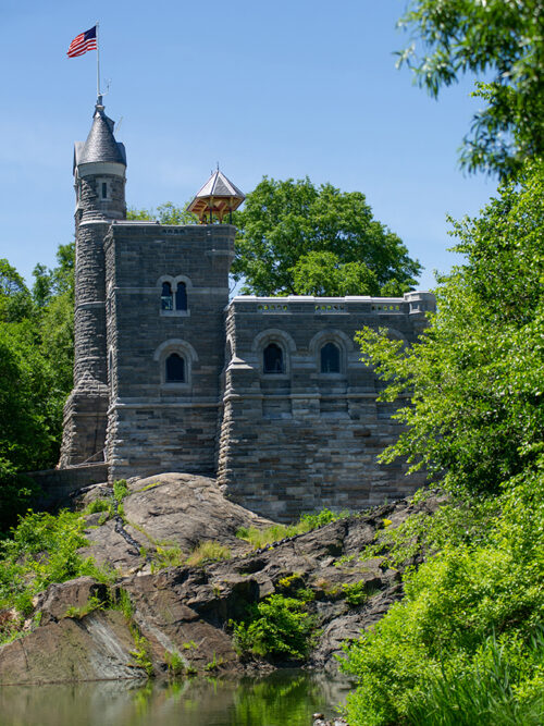 The refurbished castle in brilliant sunlight, with an American flag flying from the top