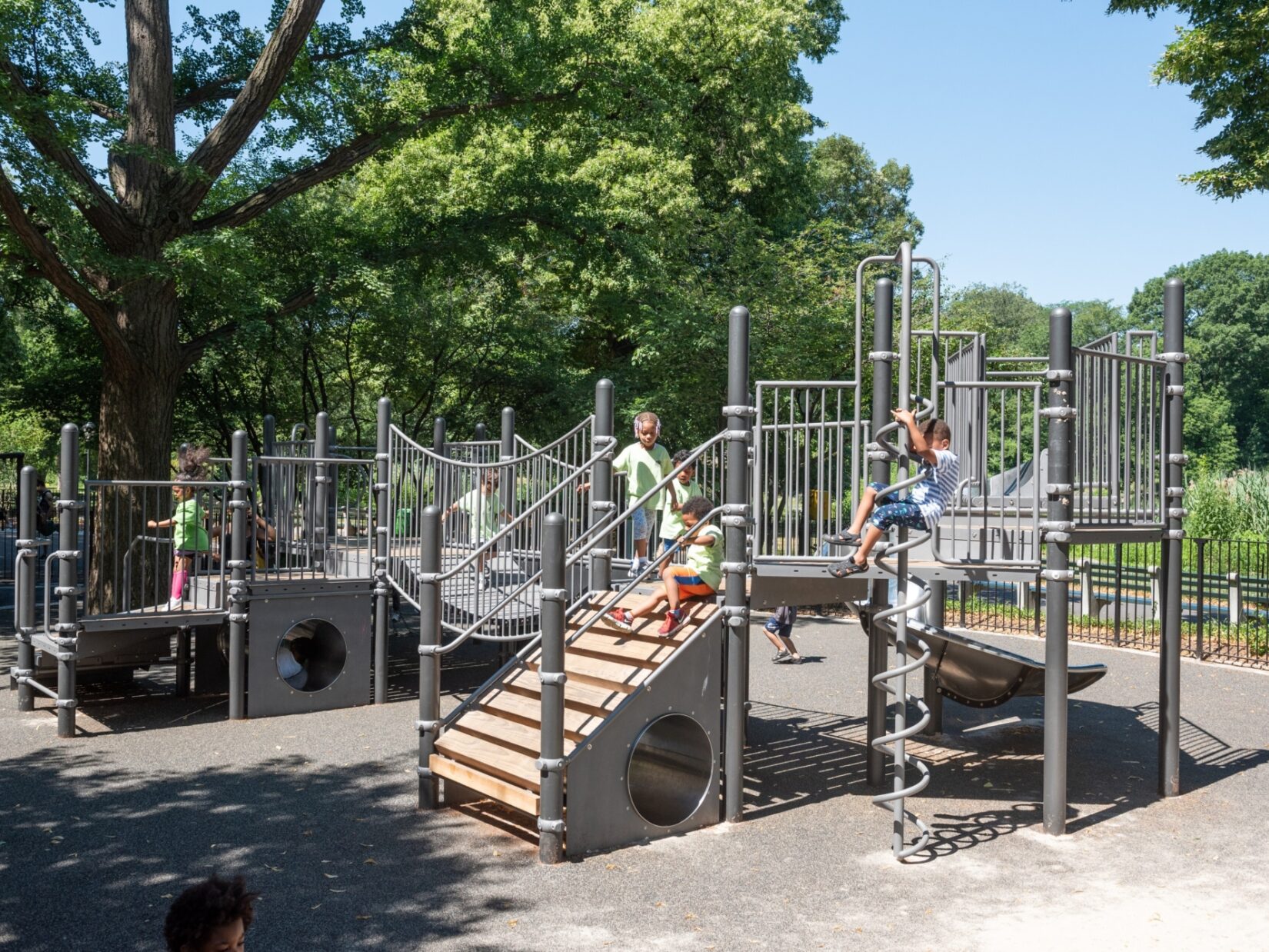 Small children enjoy the play structures in the playground