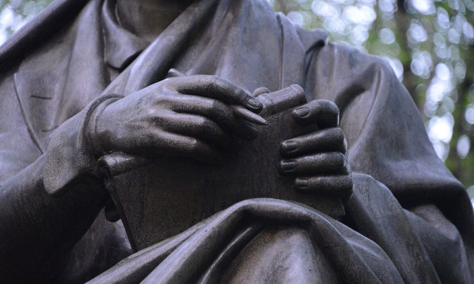 A close-up shot of the hands of the statue "Sir Walter Scott"