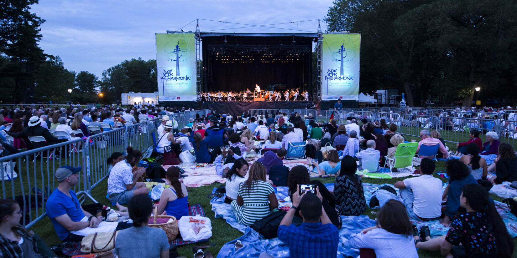 New York Philharmonic performs in Central Park on a summer evening