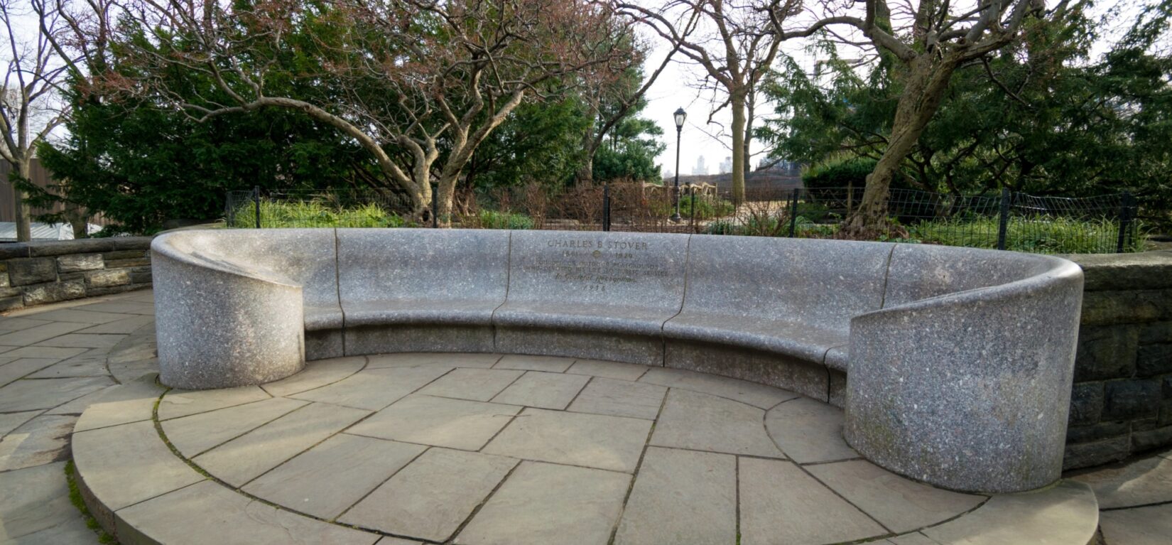 The granite bench is long and gently curved.