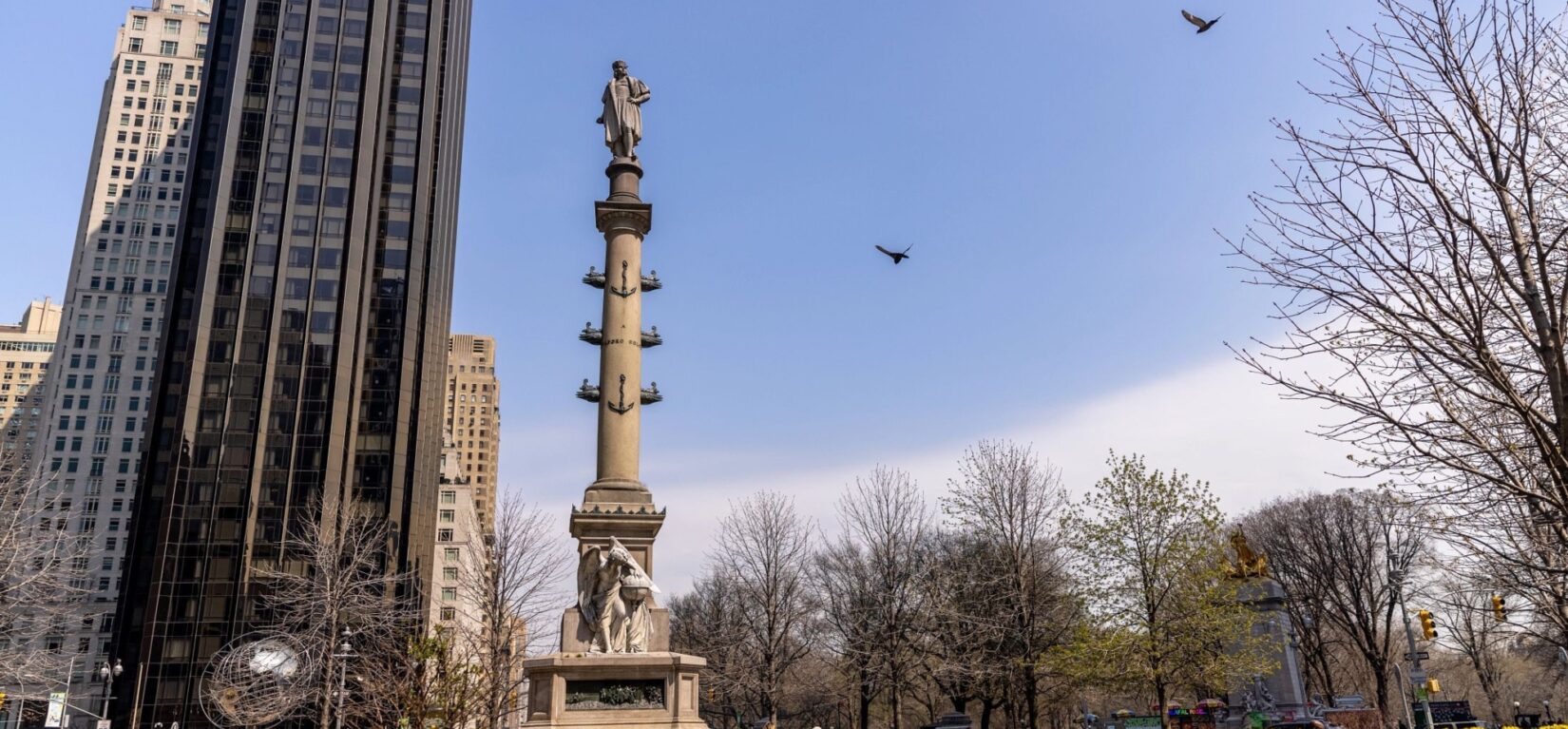 The statue to Columbus, at the epicenter of the circle, is silhouetted against a wintry sky.