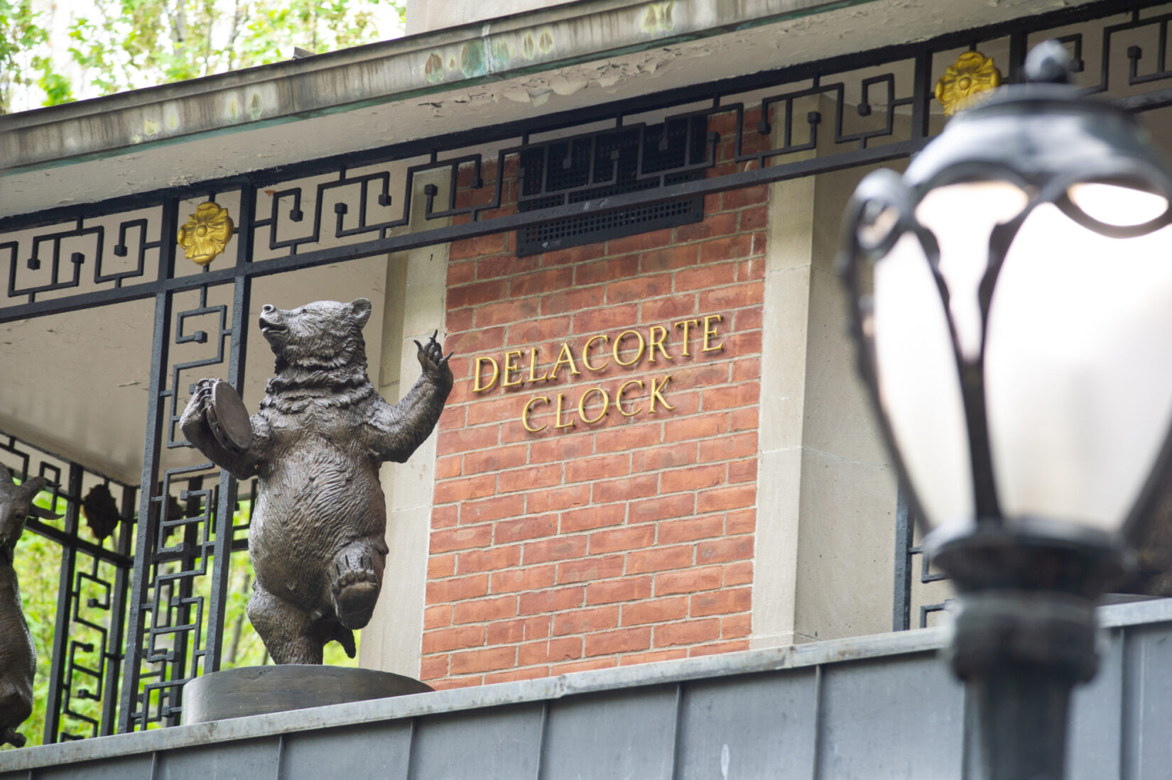 A playful statue of a bear dances around the Delacorte Clock