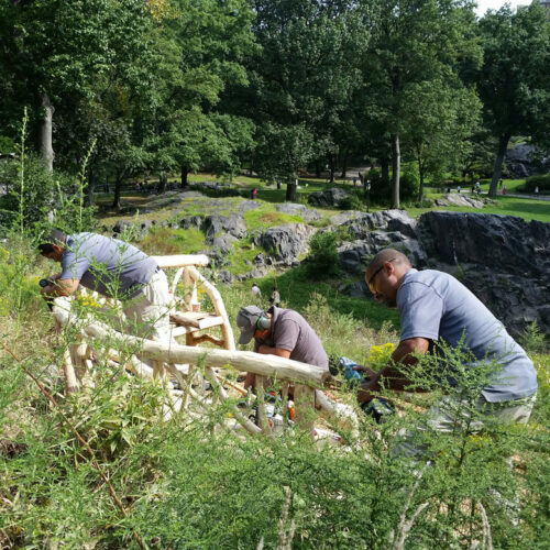 Conservancy artisans contructing rustic seating