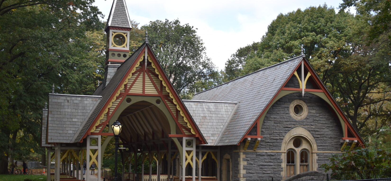 The Dairy Visitor Center & Gift Shop, a Victorian-style building nestled among the trees of Central Park.