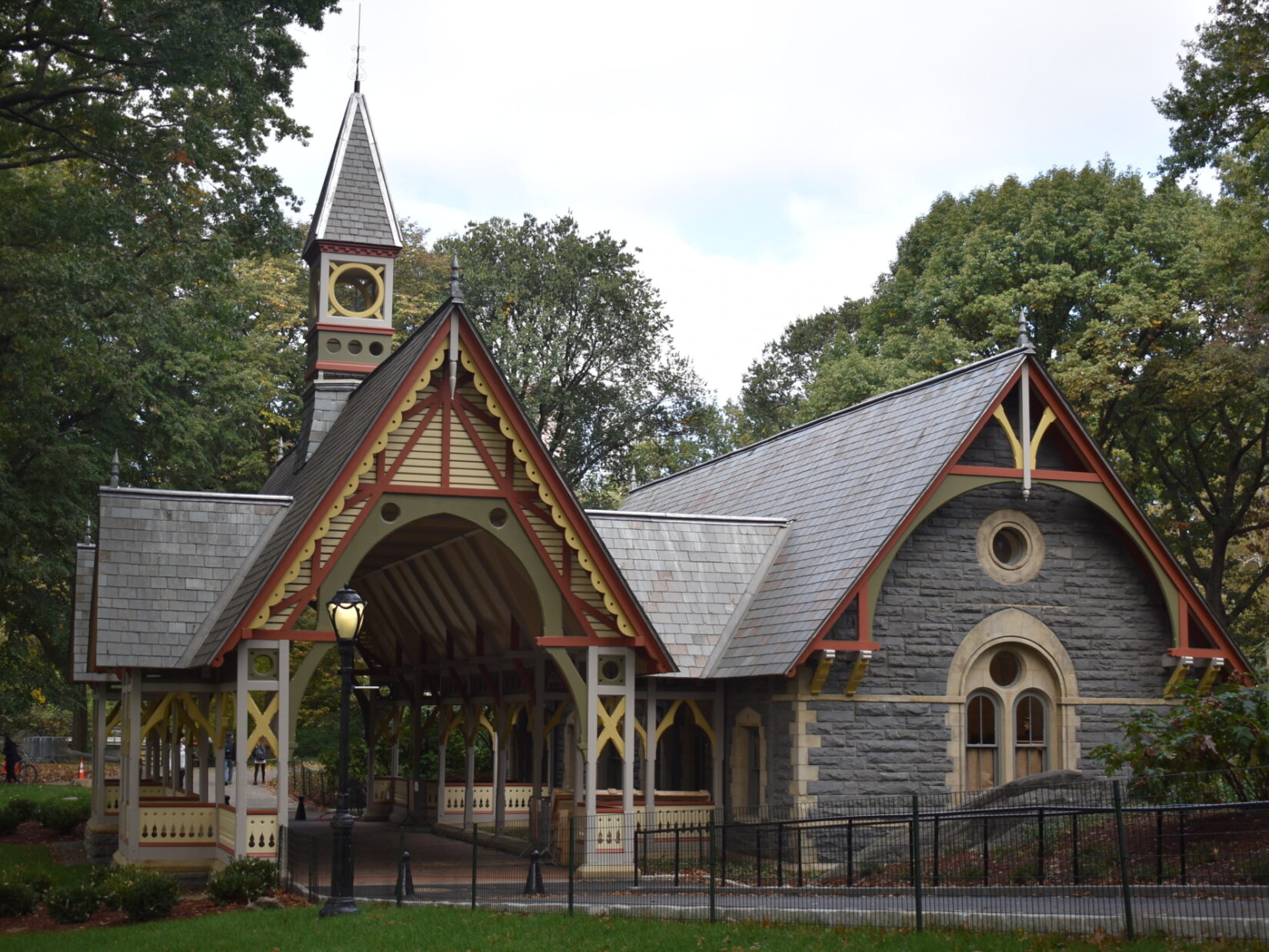 The Dairy Visitor Center & Gift Shop, a Victorian-style building nestled among the trees of Central Park.