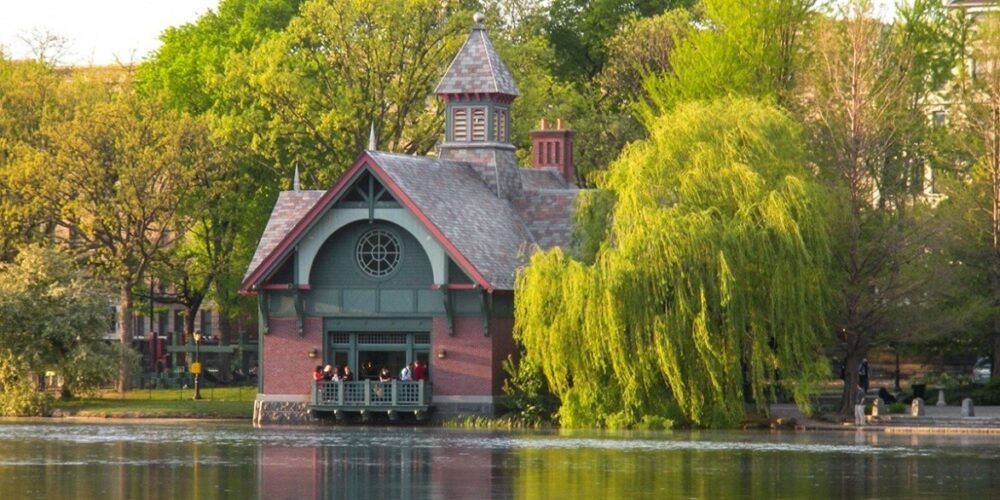 The Dana Center pictured on the banks of the Harlem Meer, surrounded by trees