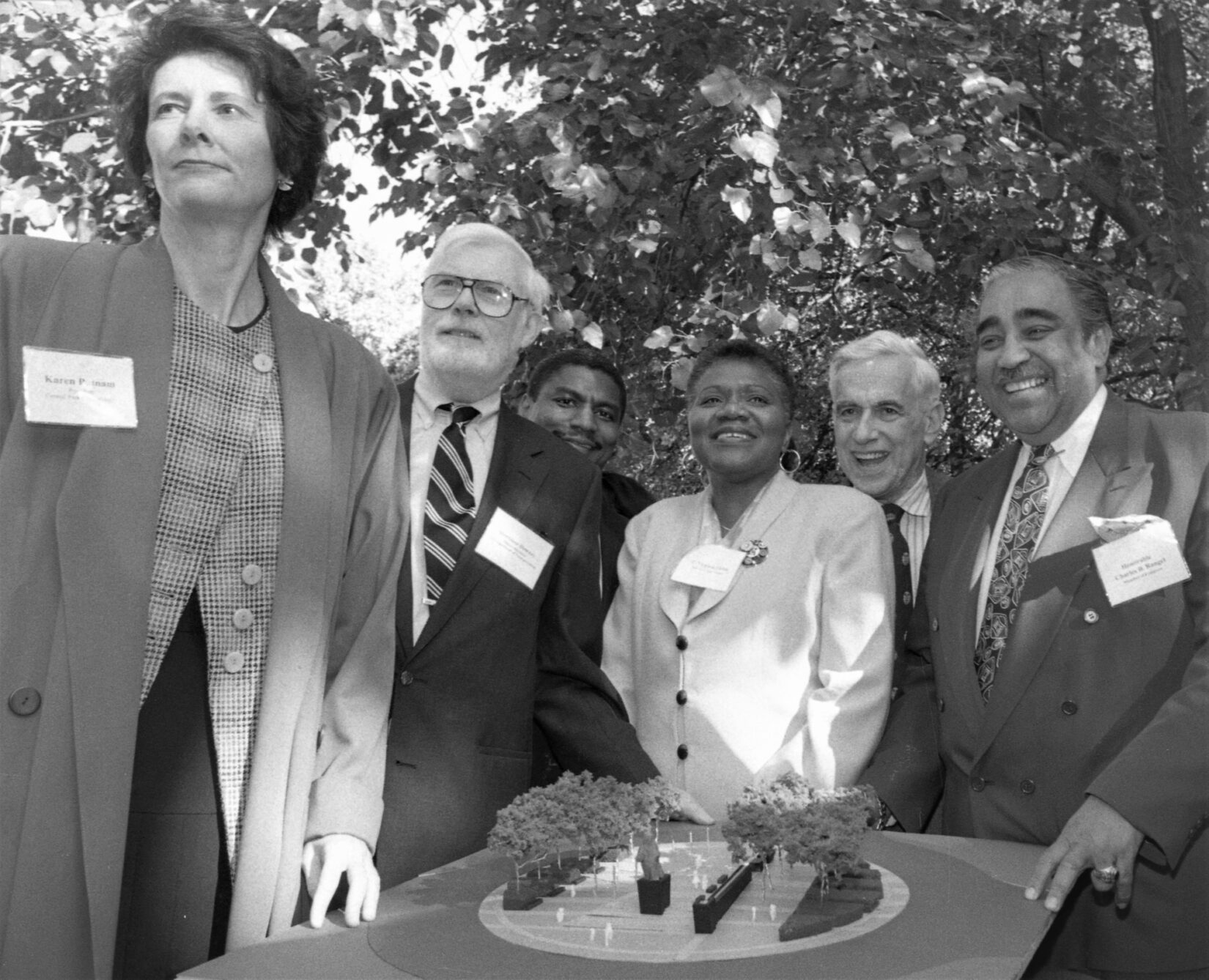 Black-and-white photo of luminaries surrounding a model of the circle.