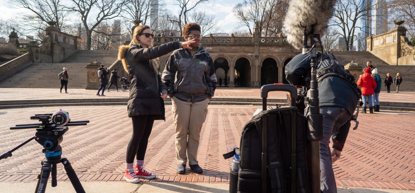 Two women map out a film shoot on Bethesda Terrace in winter