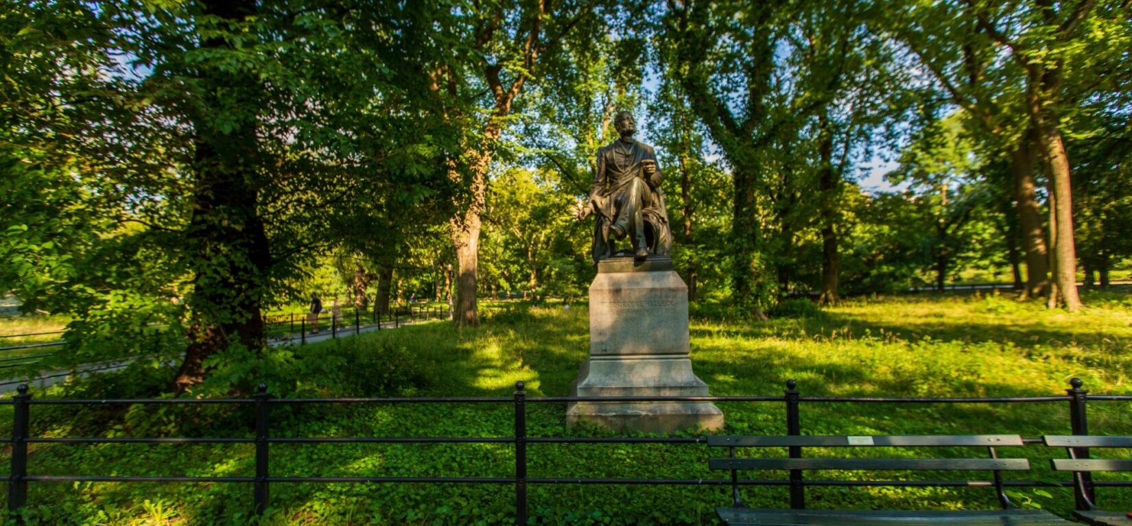 The statue of Halleck sitting under leafy trees