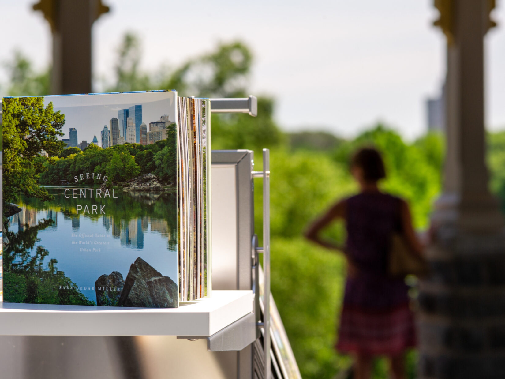 A picture book on sale at the gift shop, with the greenery of the Park in the background