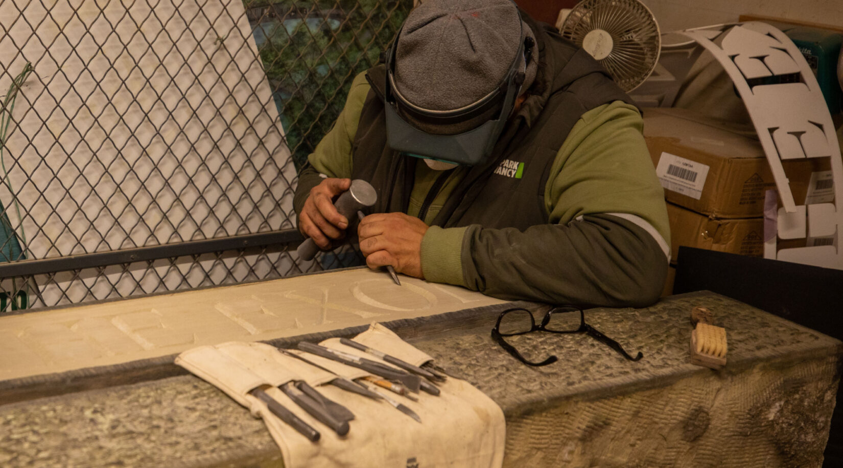 Conservancy staff member engraves Gate of the Exonerated into the stone.