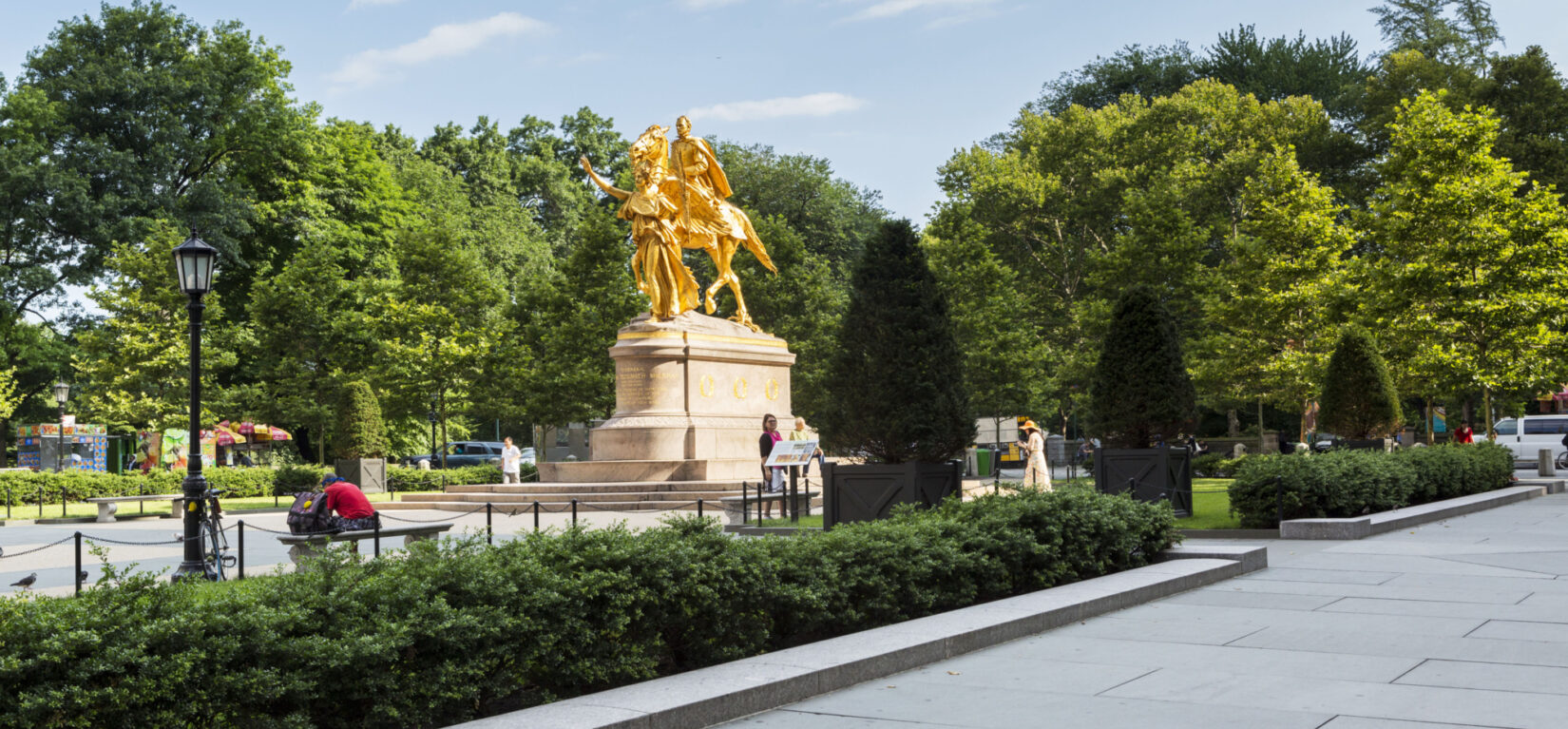 The statue is seen from the southeast corner of Grand Army Plaza, looking north toward Central Park