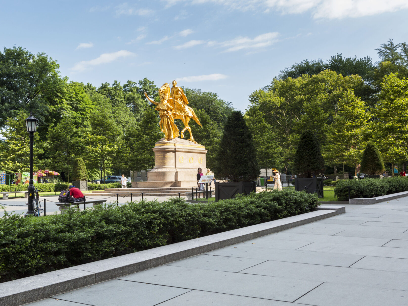 The statue is seen from the southeast corner of Grand Army Plaza, looking north toward Central Park