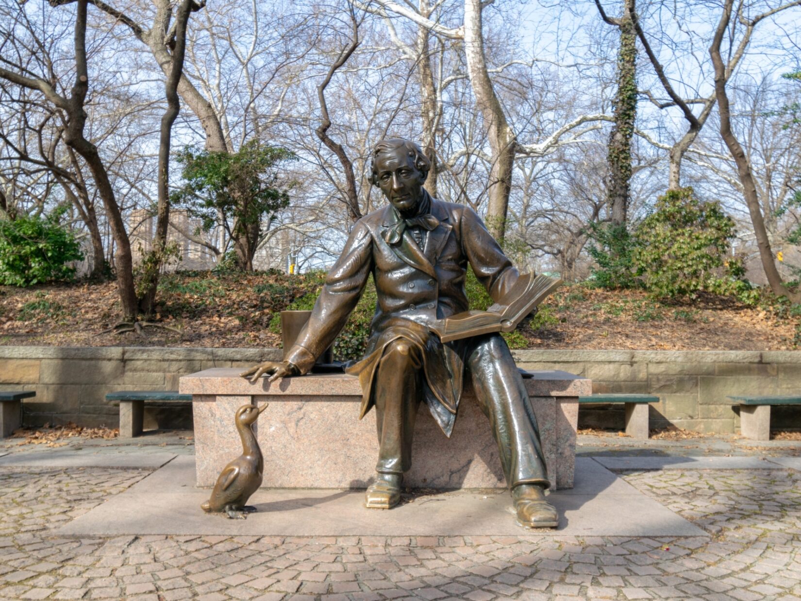 The sculpture of the author is viewed by a sculpture of an ugly duckling