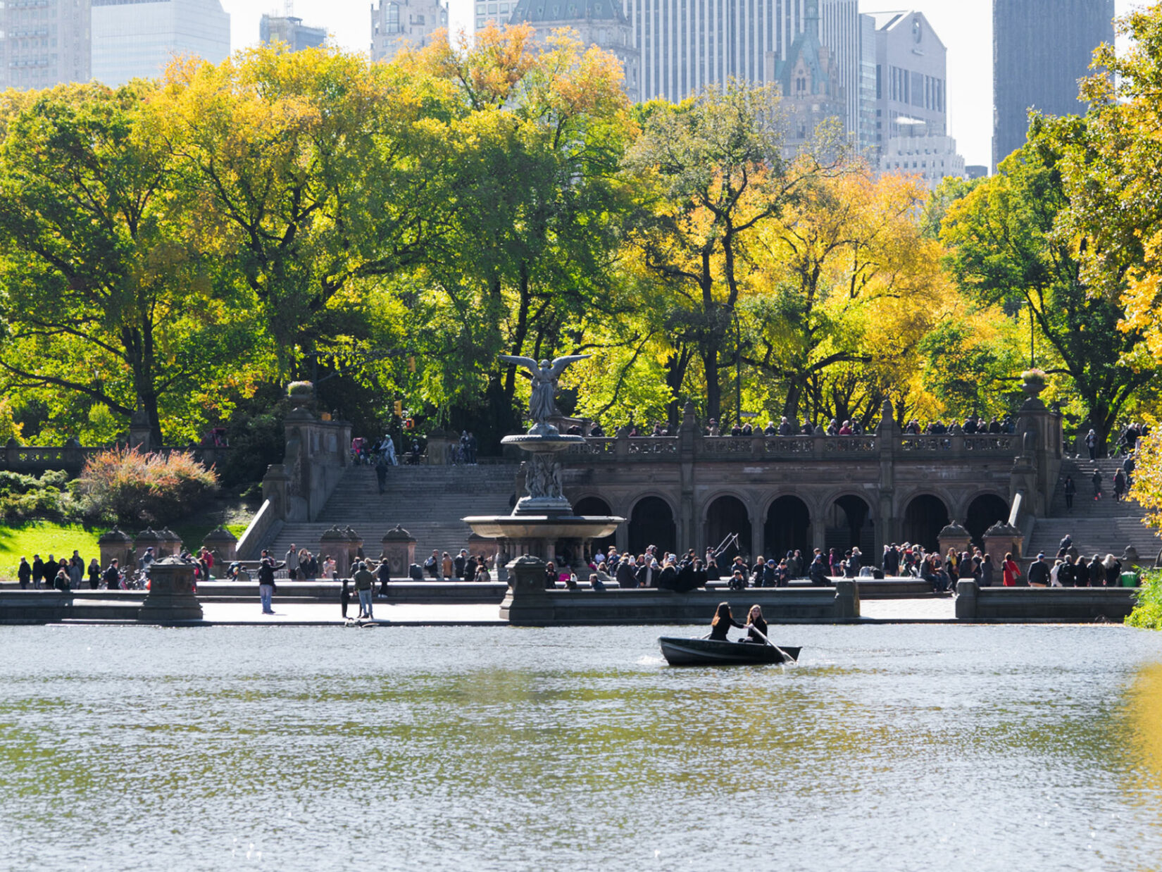 Looking across the Lake to Bethesda Terrace thronging with parkgoers