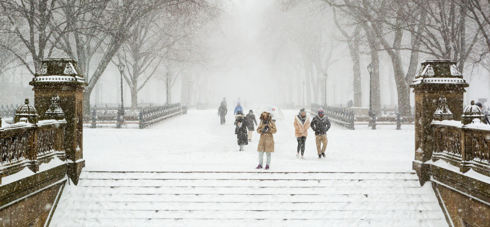 A view looking down the Mall from the steps of Bethesda Terrace on a snowy winter day