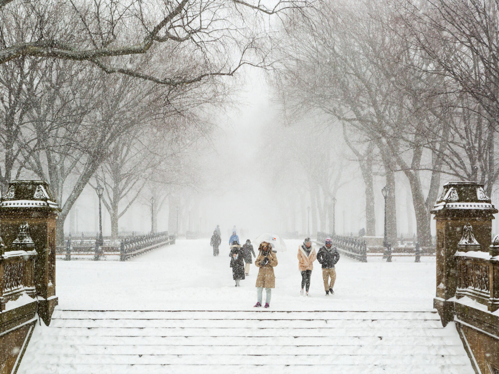 A view looking down the Mall from the steps of Bethesda Terrace on a snowy winter day