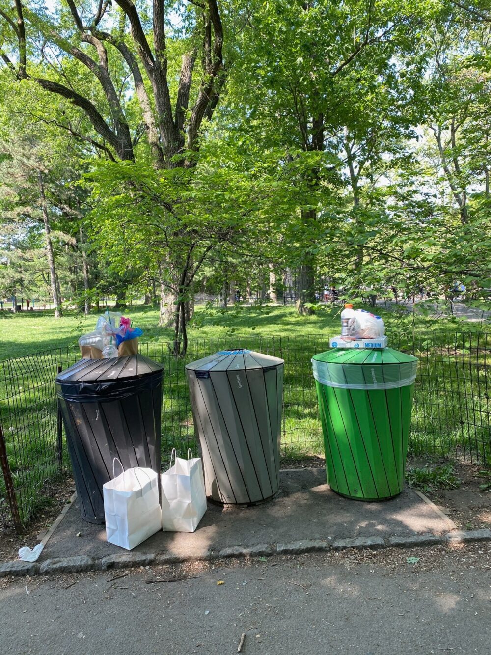 Trash cans pictured full to overflowing