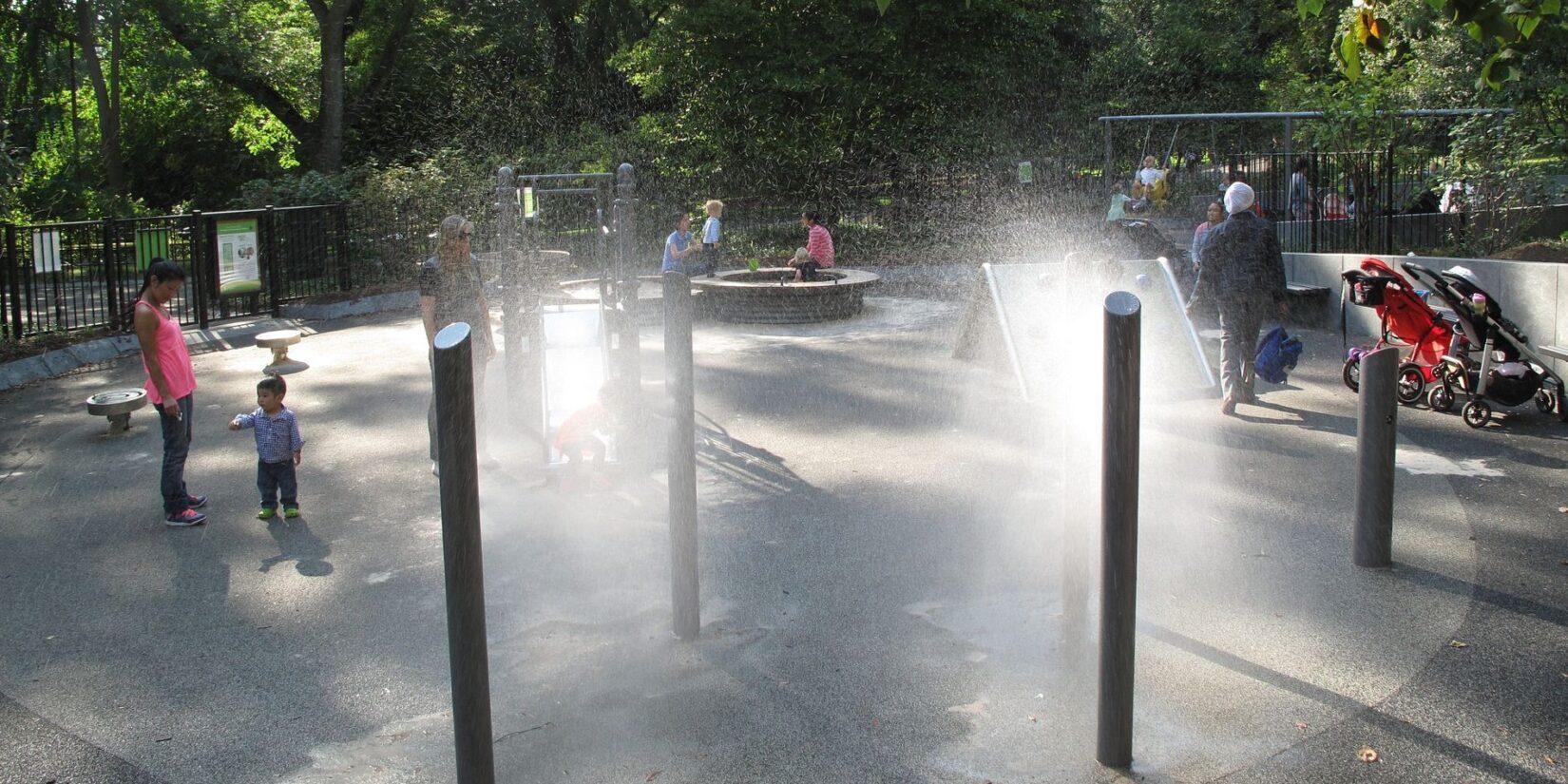 The water feature consists of three poles spraying a cooling mist.