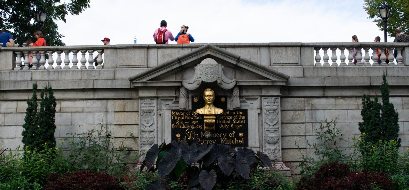 Strollers on the jogging path are seen above the memorial