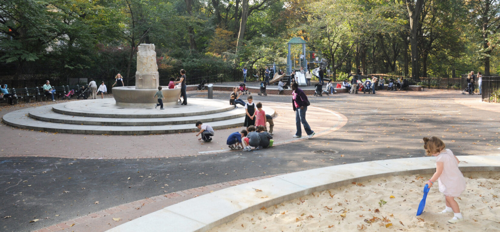 Children enjoying the fountain feature of the playground