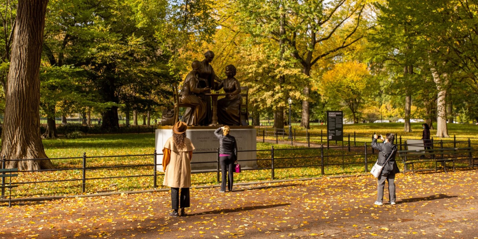 The monument is admired by a few parkgoers in autumn