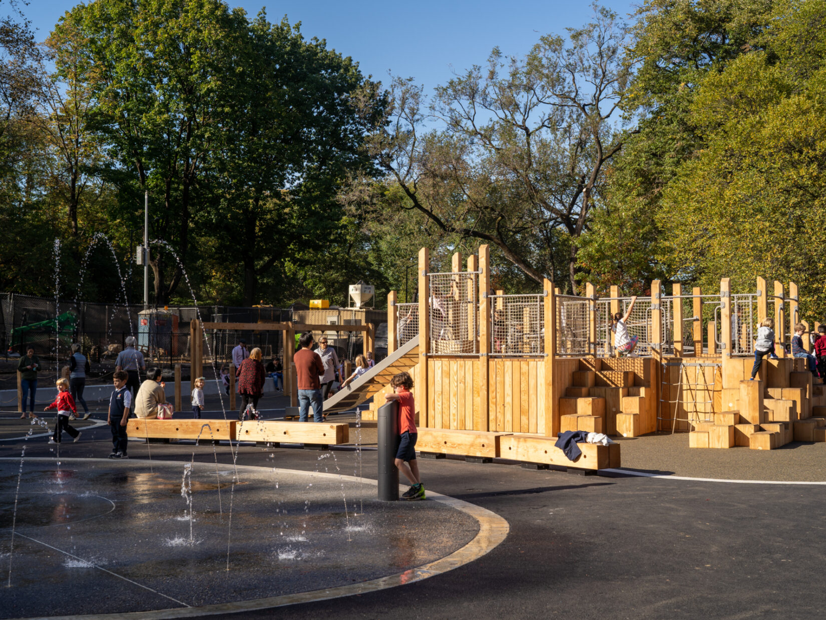 Children enjoying the Kempner Playground's wooden apparatus