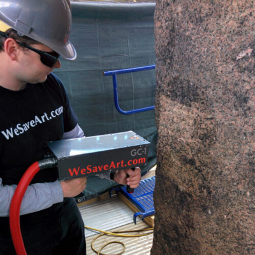 A worker uses a laser to clean the Obelisk