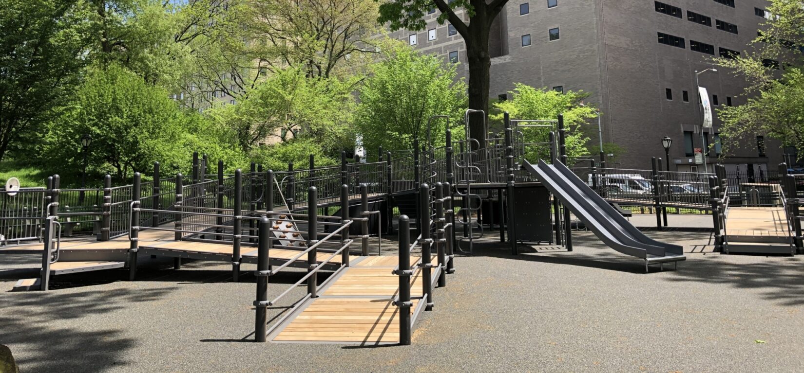 The playground is seen with apartment buildings in the background, showing how available it is to the community.