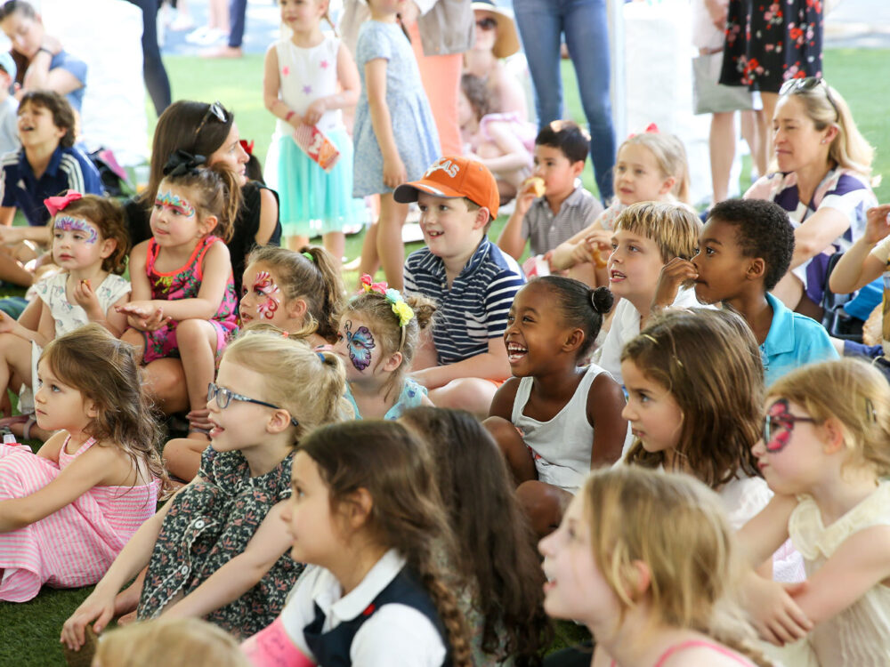 Kids sit and enjoy the entertainment