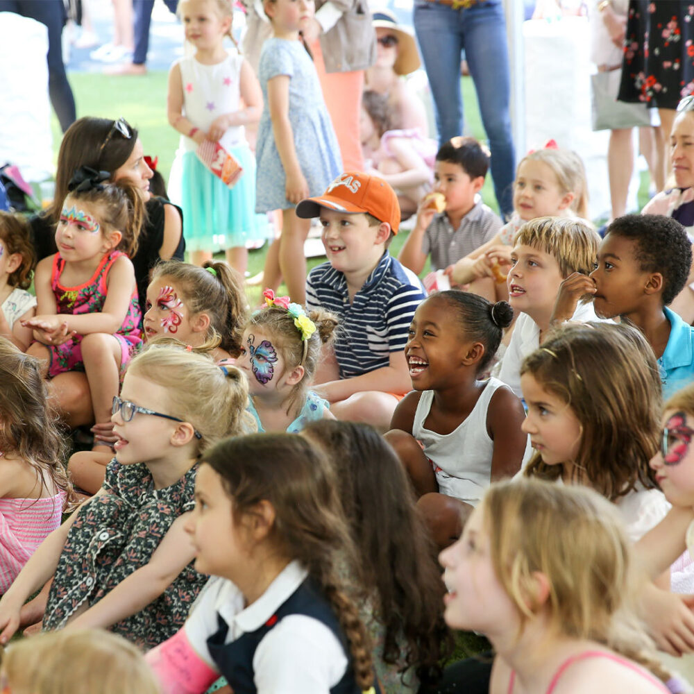 Kids sit and enjoy the entertainment