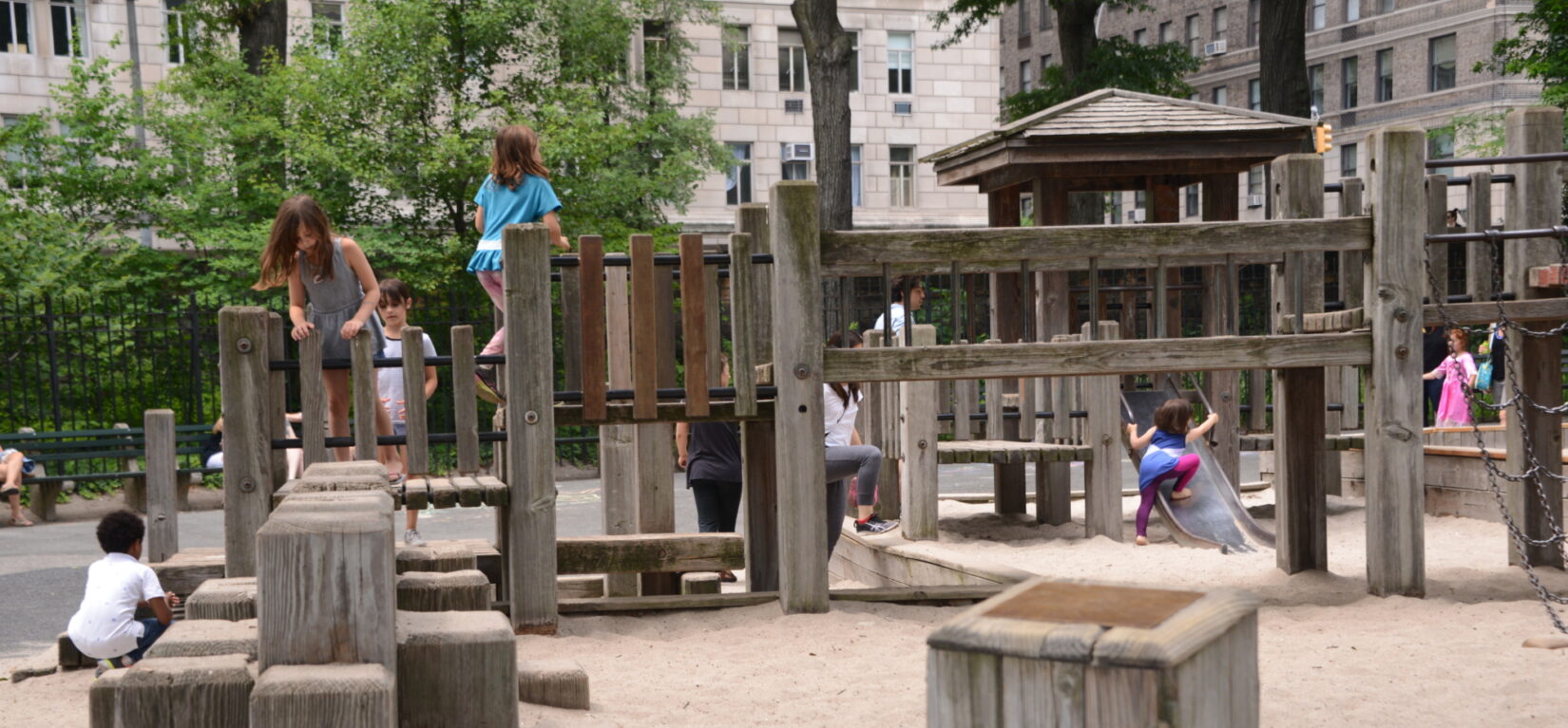 Small children clambor on the play structures