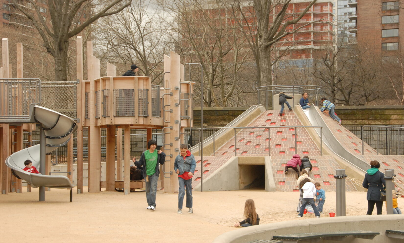 Children take advantage of multiple climbing and sliding options on a brisk, late-autumn day.