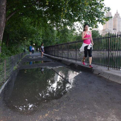 A large puddle on the running track shows the need for reconstruction