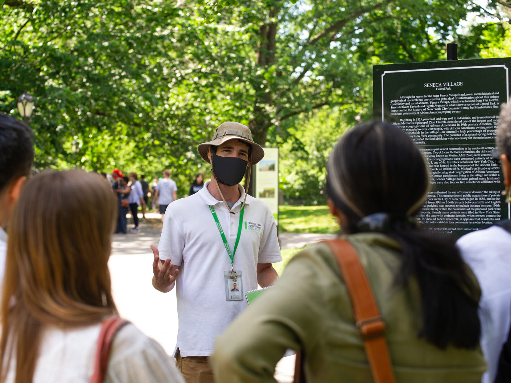 A Conservancy guide addresses a tour group at the Seneca Vaillage site