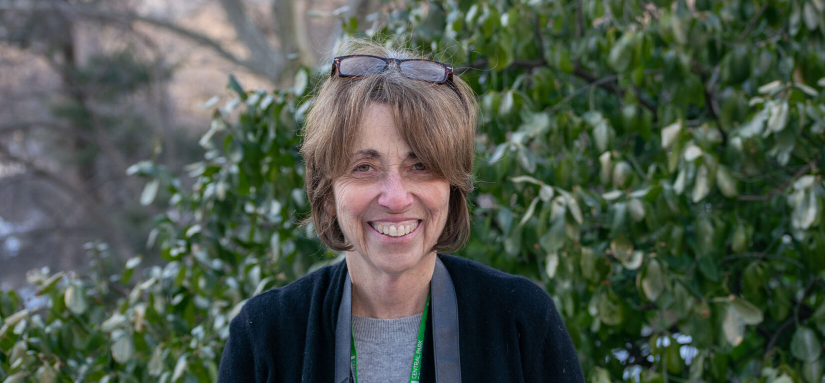 Portrait image of Sara Cedar Miller, seen in front of Park greenery