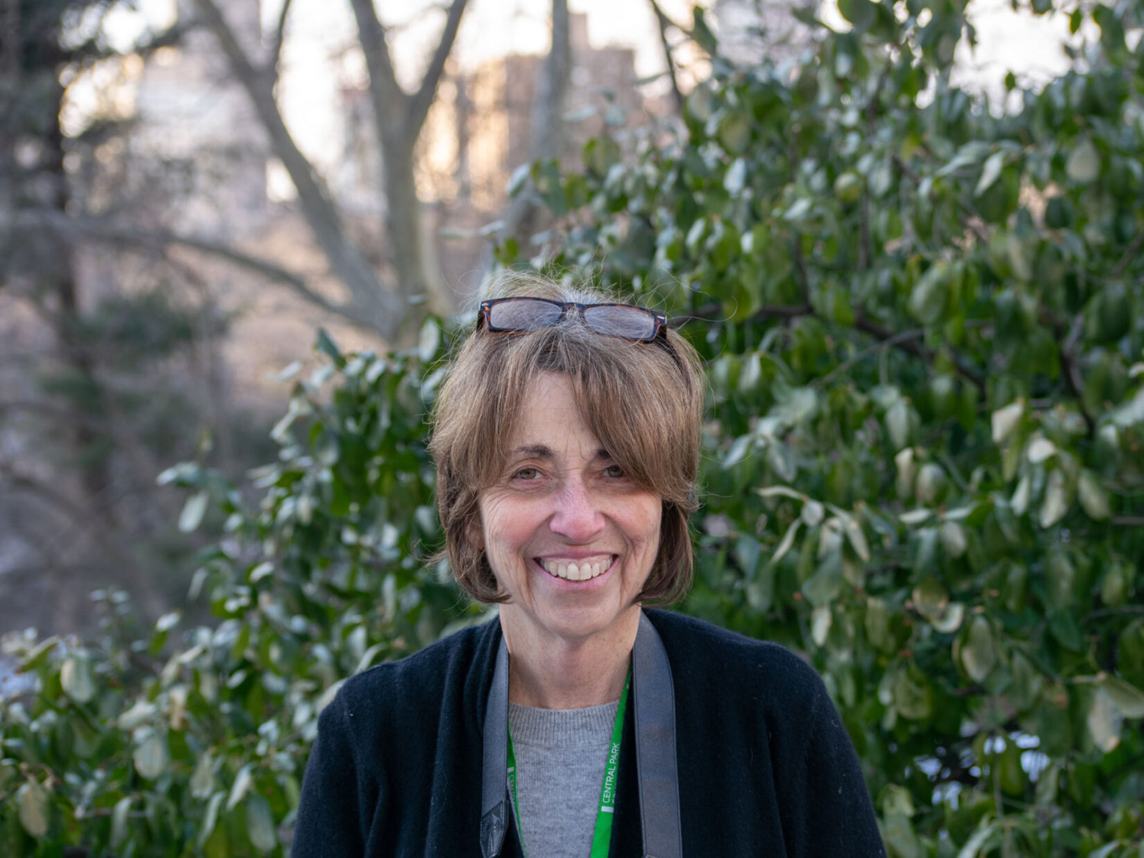 Portrait image of Sara Cedar Miller, seen in front of Park greenery